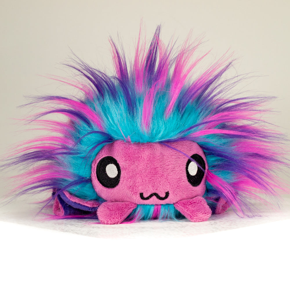 Front view of a cuttlepod plush toy, showcasing its unique form with large, cartoonish eyes, ruffled fins, and a cuddly, furry texture.