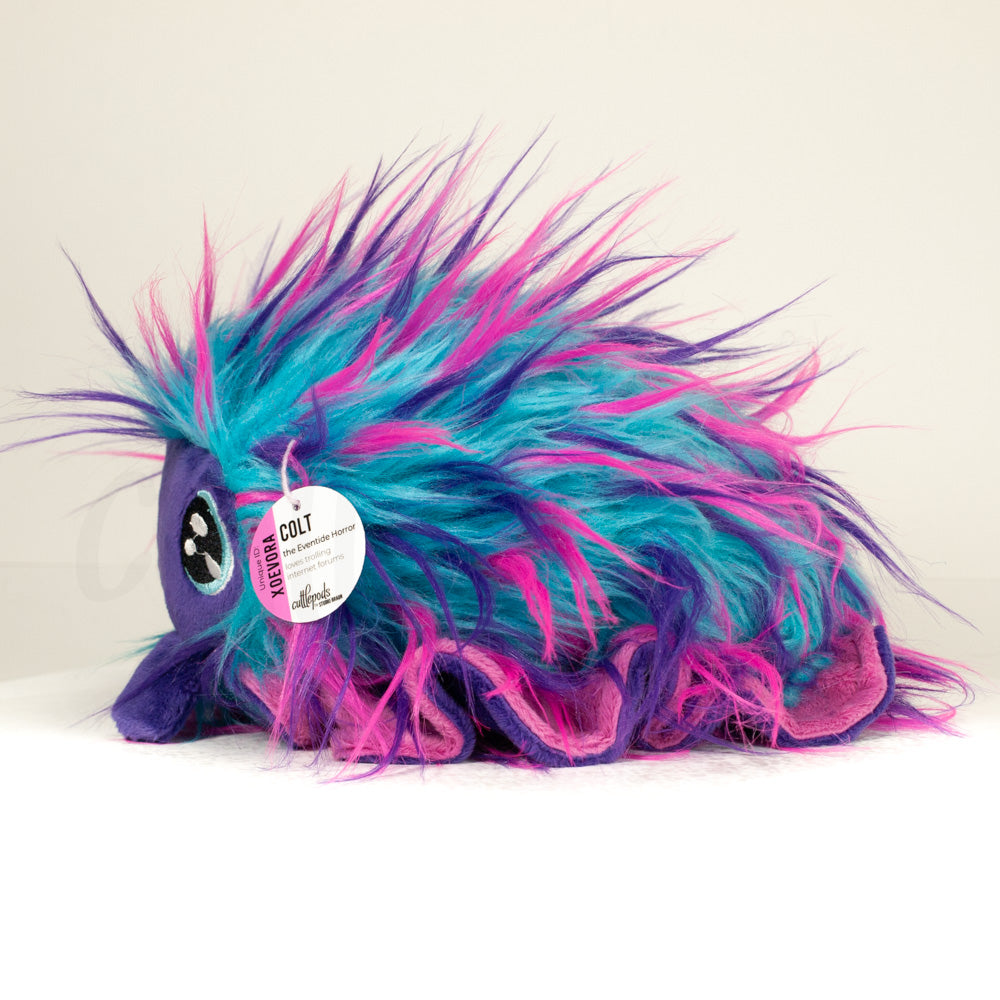 Front view of a cuttlepod plush toy, showcasing its unique form with large, cartoonish eyes, ruffled fins, and a cuddly, furry texture.