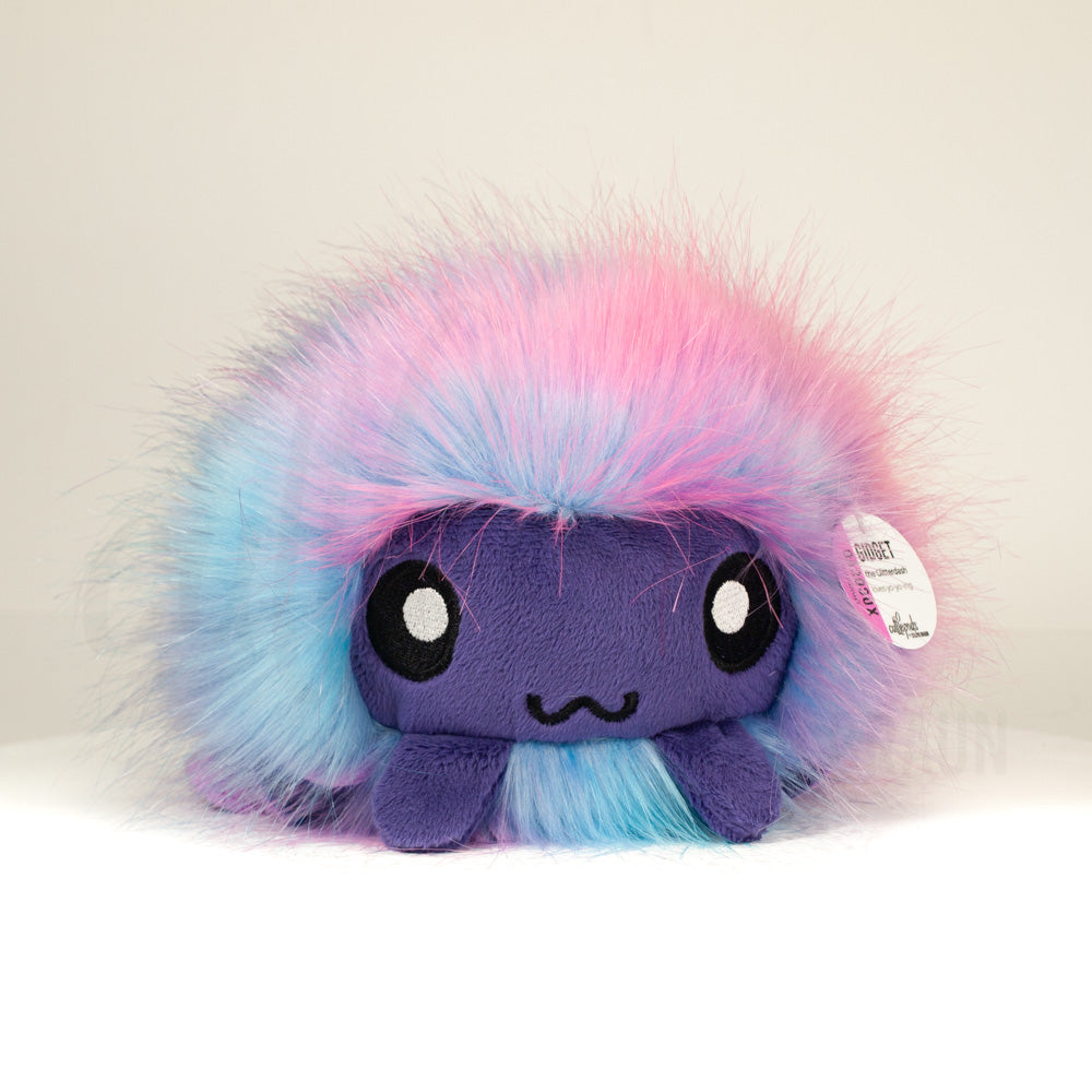 Front view of a cuttlepod plush toy, showcasing its unique form with large, cartoonish eyes, ruffled fins, and a cuddly, furry texture.