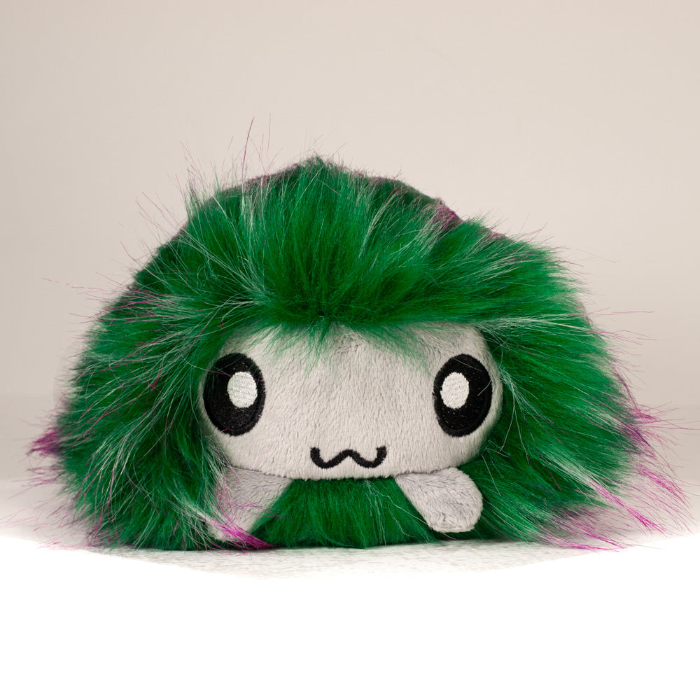 Front view of a cuttlepod plush toy, showcasing its unique form with large, cartoonish eyes, ruffled fins, and a cuddly, furry texture.