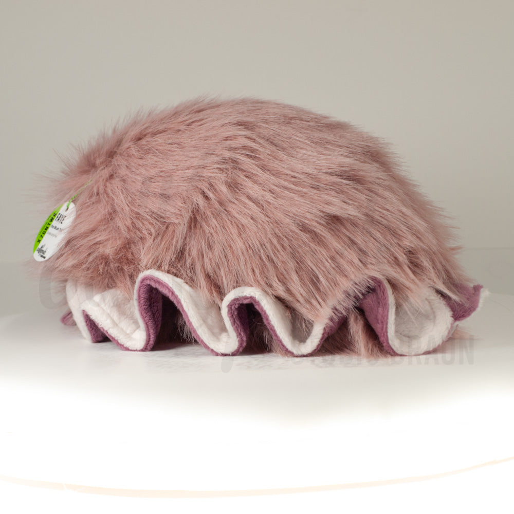 Slightly angled back view of a cuttlepod plush toy, highlighting two-tone ruffled fins, and a cuddly, furry body that comes to a soft point at the rear.