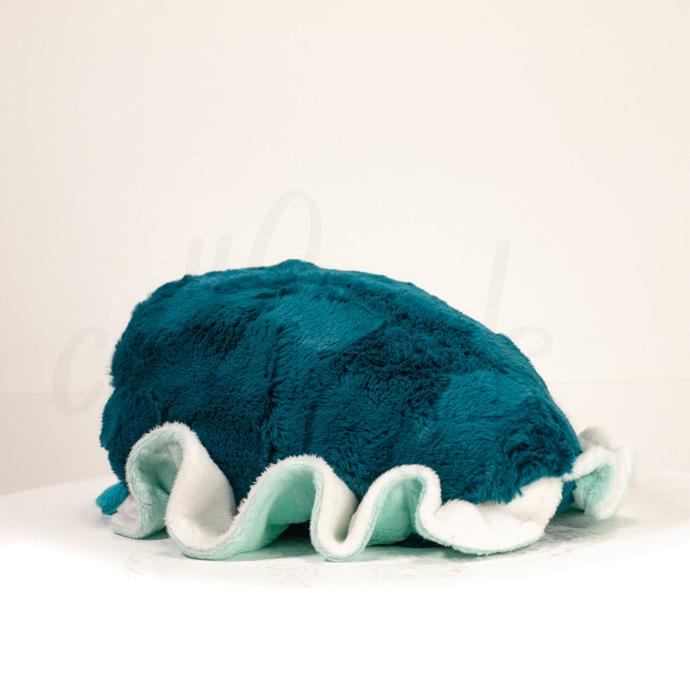 Slightly angled back view of a cuttlepod plush toy, highlighting two-tone ruffled fins, and a cuddly, furry body that comes to a soft point at the rear.