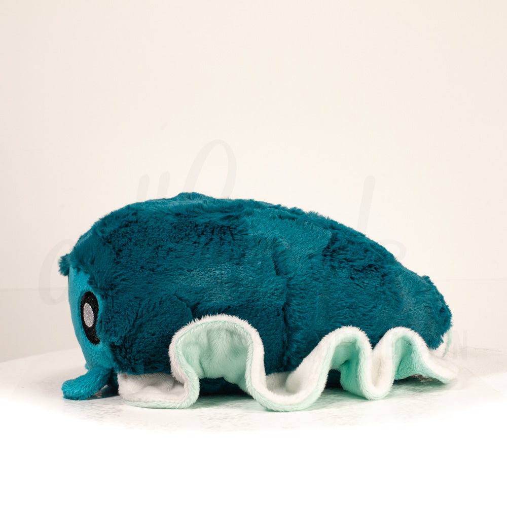 Side profile view of a cuttlepod plush toy, showcasing two-tone ruffled fins, and a cuddly, furry body.