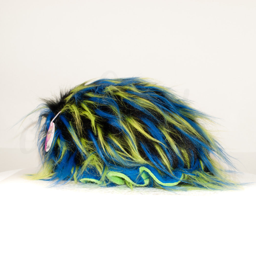 Slightly angled back view of a cuttlepod plush toy, highlighting two-tone ruffled fins, and a cuddly, furry body that comes to a soft point at the rear.