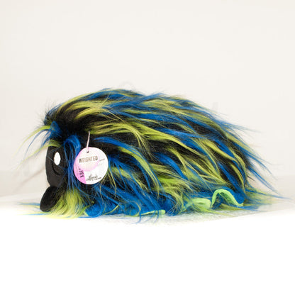 Side profile view of a cuttlepod plush toy, showcasing two-tone ruffled fins, and a cuddly, furry body.