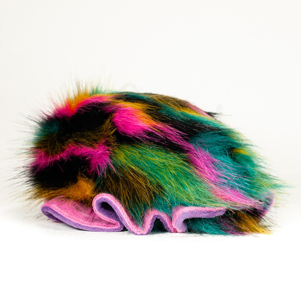 Slightly angled back view of a cuttlepod plush toy, highlighting two-tone ruffled fins, and a cuddly, furry body that comes to a soft point at the rear.