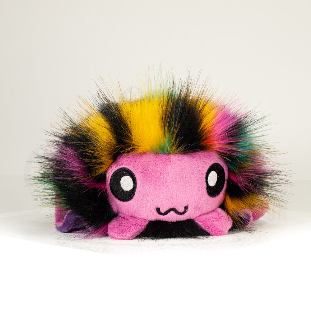 Front view of a cuttlepod plush toy, showcasing its unique form with large, cartoonish eyes, ruffled fins, and a cuddly, furry texture.