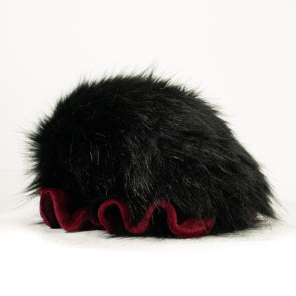 Slightly angled back view of a cuttlepod plush toy, highlighting two-tone ruffled fins, and a cuddly, furry body that comes to a soft point at the rear.