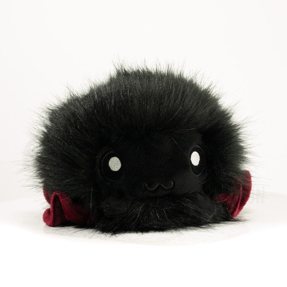 Front view of a cuttlepod plush toy, showcasing its unique form with large, cartoonish eyes, ruffled fins, and a cuddly, furry texture.