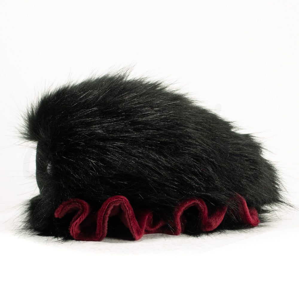 Side profile view of a cuttlepod plush toy, showcasing two-tone ruffled fins, and a cuddly, furry body.