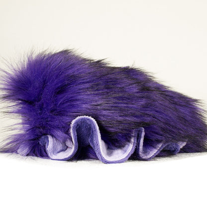 Side profile view of a cuttlepod plush toy, showcasing two-tone ruffled fins, and a cuddly, furry body.