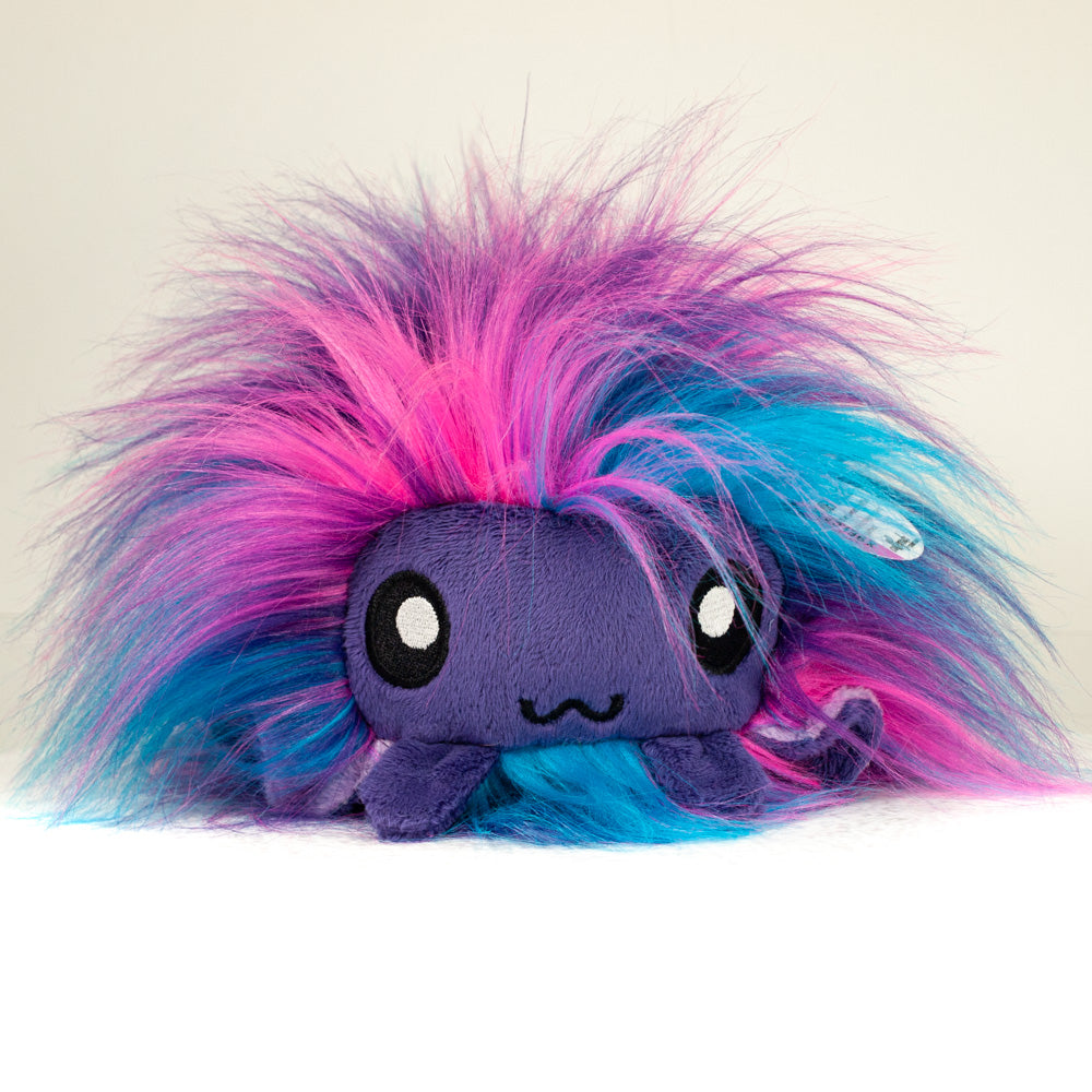 Front view of a cuttlepod plush toy, showcasing its unique form with large, cartoonish eyes, ruffled fins, and a cuddly, furry texture.