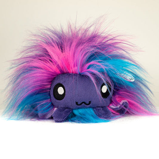 Front view of a cuttlepod plush toy, showcasing its unique form with large, cartoonish eyes, ruffled fins, and a cuddly, furry texture.