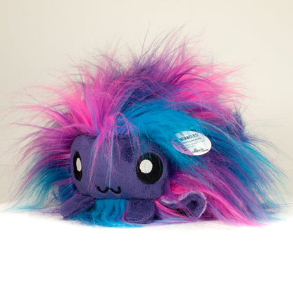 Side profile view of a cuttlepod plush toy, showcasing two-tone ruffled fins, and a cuddly, furry body.