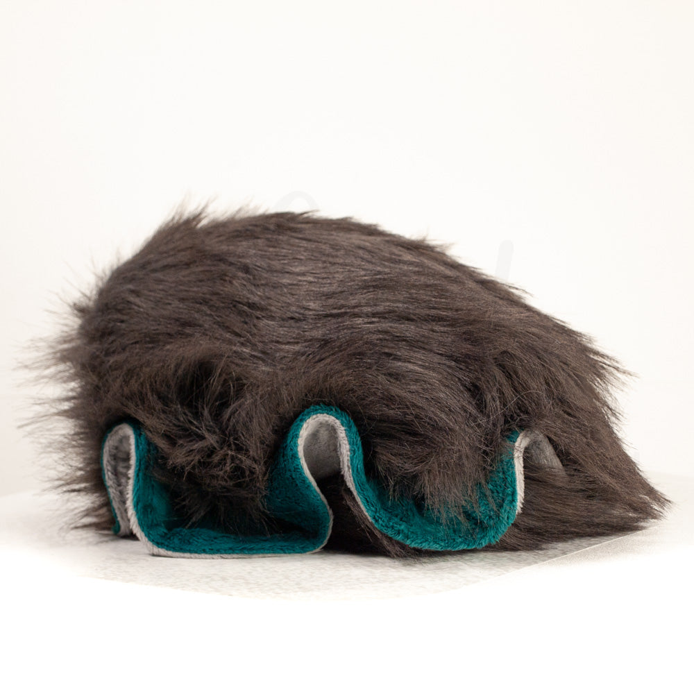 Slightly angled back view of a cuttlepod plush toy, highlighting two-tone ruffled fins, and a cuddly, furry body that comes to a soft point at the rear.