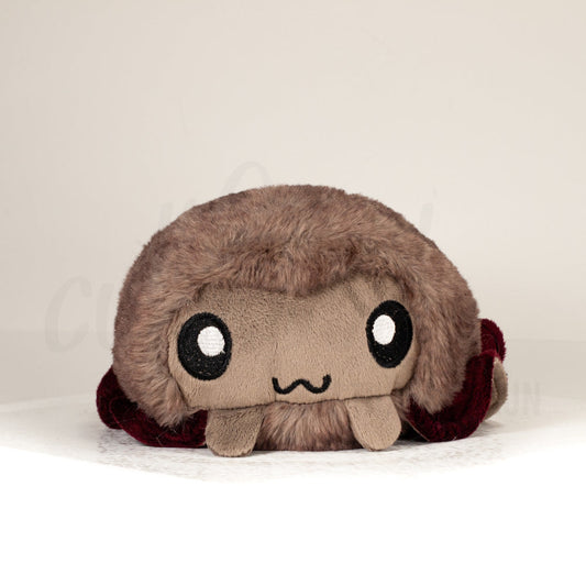 Front view of a cuttlepod plush toy, showcasing its unique form with large, cartoonish eyes, ruffled fins, and a cuddly, furry texture.