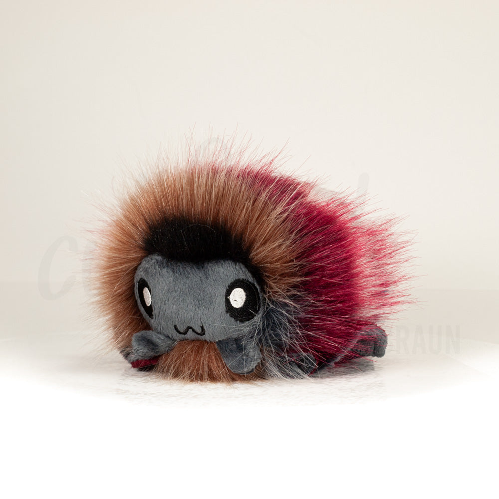 Front view of a cuttlepod plush toy, captured at a slight angle to highlight its charming features: large, cartoonish eyes, ruffled fins, and a cuddly, furry texture.