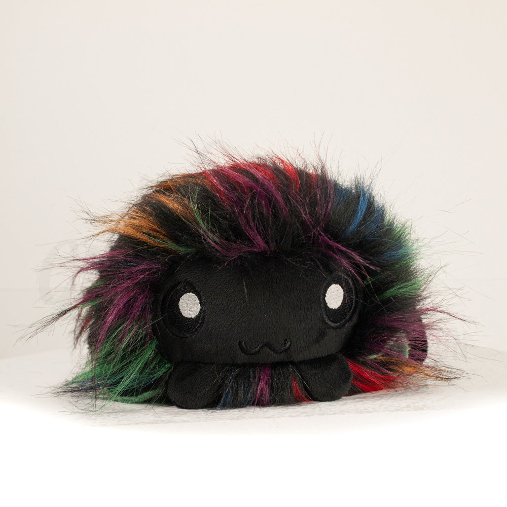 Front view of a cuttlepod plush toy, showcasing its unique form with large, cartoonish eyes, ruffled fins, and a cuddly, furry texture.