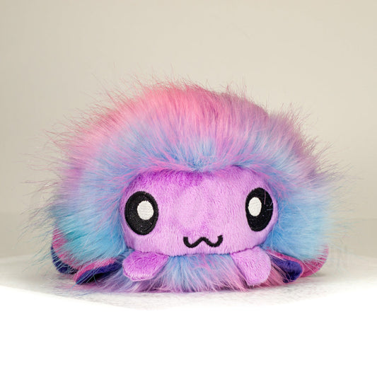 Front view of a cuttlepod plush toy, showcasing its unique form with large, cartoonish eyes, ruffled fins, and a cuddly, furry texture.